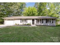 Newly painted ranch home with attached garage and spacious lawn at 805 Rowan Avenue Ext, Spencer, NC 28159