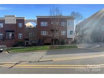 Brick front exterior of townhome with landscaping and street view at 210 Harbour Place Dr, Davidson, NC 28036