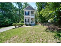 Two-story home with gray siding, black shutters, and a front porch at 3921 Sky Dr, Charlotte, NC 28226