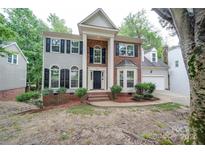 Brick two-story home with a traditional facade and landscaping at 6232 Hickory Cove Ln, Charlotte, NC 28269