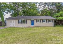 House exterior featuring a blue door and nicely landscaped yard at 704 Ryder Ave, Landis, NC 28088