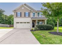 Two story home with two car garage and landscaped yard at 127 Tranquil Ct # 18A, Locust, NC 28097