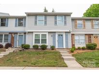 Townhouse with light gray siding and blue front door at 7340 Pebblestone Dr # C, Charlotte, NC 28212