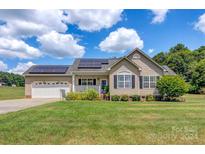 Ranch-style home with solar panels and a spacious yard at 1000 Creekside Dr, Lincolnton, NC 28092