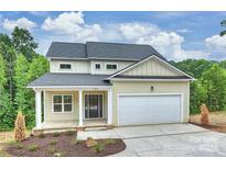 Two-story house with light beige siding and a front porch at 144 Meadow Glen Dr, Troutman, NC 28166