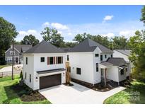 Two story white house with dark gray garage doors and a detached garage at 1529 Beckwith Pl, Charlotte, NC 28205