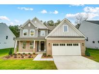 Brick two-story house with gray siding, attached garage, and landscaping at 2020 Cedar Falls Dr # 8, Waxhaw, NC 28173