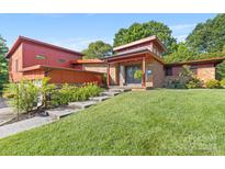 Mid-century modern home with red brick and landscaping at 640 Davie Ave, Statesville, NC 28677