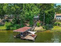 Aerial view of lakefront property with a dock and boathouse at 192 Clearview Point Dr, Mount Gilead, NC 27306