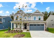 Two-story home with gray siding and stone accents at 2024 Cedar Falls Dr # 9, Waxhaw, NC 28173