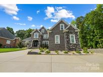 Two-story home with stone and brick exterior, landscaping, and driveway at 531 Coman Ln, Kings Mountain, NC 28086