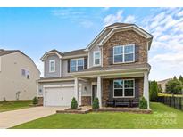 Stunning two-story home with stone accents and a welcoming front porch at 3008 Dundee Ln, Fort Mill, SC 29707