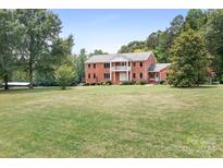 Brick house with a large front yard and mature trees at 4299 Randleman Rd, Iron Station, NC 28080