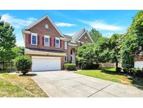 Brick two-story house with a large driveway and mature trees at 8534 Headford Rd, Charlotte, NC 28277