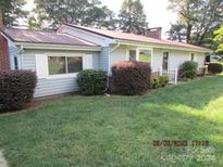 Ranch style home with mature landscaping and a large yard at 115 Sunrise Cir, Shelby, NC 28150