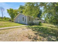 Charming gray house with a front porch and landscaped yard at 1021 Wall St, Statesville, NC 28677