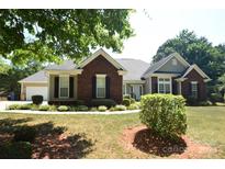 Brick and siding ranch home with landscaped yard at 6929 Plough Dr, Charlotte, NC 28227