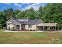 Two story house with stone accents, covered porch and detached garage at 213 Press Sweezy Rd, Kings Mountain, NC 28086