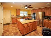 Large kitchen with an island, granite counters, and stainless steel appliances at 44097 Nc 740 Hwy, New London, NC 28127
