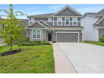 Two-story home with gray siding and stone accents at 116 Hornbeam Ln, Mooresville, NC 28117