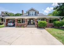 Brick home with a large front porch and driveway at 724 N Aspen St, Lincolnton, NC 28092