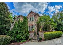 Stone home exterior with lush landscaping and a welcoming entrance at 1008 Medinah Ct, Waxhaw, NC 28173