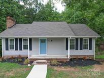 Newly renovated ranch home with gray siding and blue door at 526 Manchester Rd, Mount Gilead, NC 27306