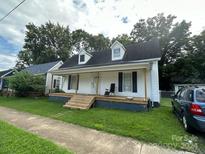 White house with front porch and mature trees at 505 Cemetary St, Salisbury, NC 28144