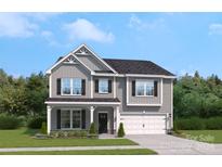 Two story home with gray siding, two-car garage, and landscaping at 219 Coronado Ave # 59, Matthews, NC 28104