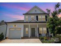 Two-story white house with gray roof, front porch, and attached garage at 29060 Low Country Ln, Lancaster, SC 29720