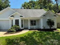 Charming one-story home with gray siding, landscaping, and a two-car garage at 258 Indian Paint Brush Dr, Mooresville, NC 28115