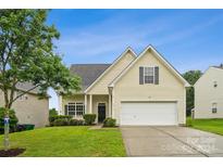 Attractive two-story house with a landscaped lawn and a two-car garage at 14131 Bernardy Ln, Charlotte, NC 28269