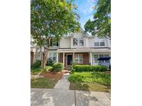 Two story townhome with brick and siding exterior, landscaping, and walkway at 16841 Greenlawn Hills Ct, Charlotte, NC 28213