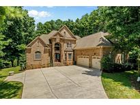 Brick house with a three-car garage and landscaping at 106 Liva Ln, Mooresville, NC 28117