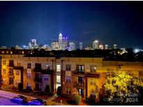 Night view of the city skyline from a condo building at 12119 Brooklyn Ave, Charlotte, NC 28204