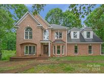 Brick house with a two-car garage and landscaped yard at 15610 Youngblood Rd, Charlotte, NC 28278