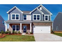 Two-story house with gray siding, stone accents, and a two-car garage at 1813 Augustine St, Monroe, NC 28112