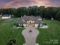 Luxury home with expansive grounds, pool, and sports court at 514 Billy Howey Rd, Waxhaw, NC 28173