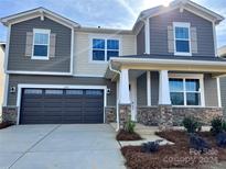 Two story house with gray siding and stone accents at 1483 Honey Trl, Monroe, NC 28112