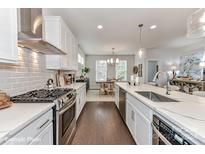 Modern kitchen with white cabinets and island at 136 Wesser St # 53, Davidson, NC 28036
