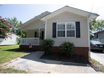 Tan house with a brick base, porch, and landscaping at 195 Edward Ave # 13, Concord, NC 28025