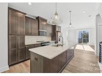 Modern kitchen with island, stainless steel appliances, and dark cabinetry at 1432 Hamilton St # 14, Charlotte, NC 28206