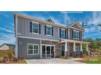 Two-story home with gray siding, stone accents, and a welcoming front porch at 198 Giant Oak Ave, Statesville, NC 28677