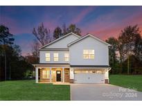 Two-story white house with brick accents, two-car garage, and a well-manicured lawn at 4508 Haida Ct, Gastonia, NC 28056