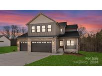 Two-story craftsman home with stone accents and a three-car garage at 171 Heartland Dr # 7, Rock Hill, SC 29732