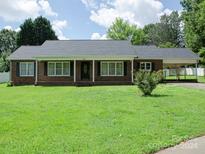 Brick ranch home with carport, landscaping, and large yard at 452 Mocksville Hwy, Statesville, NC 28625