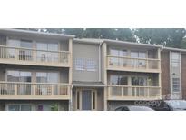 Two-story townhome building with balconies and parking at 1600 H Arlyn Cir, Charlotte, NC 28213