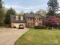 Two-story brick home with attached garage and landscaping at 163 Mccrary Rd, Mooresville, NC 28117