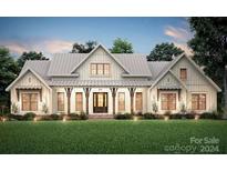 Farmhouse style home with a metal roof and large front porch at 182 Shagbark Ct, Mount Gilead, NC 27306