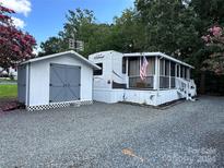 Mobile home with shed and spacious screened porch at 113 Hummingbird Cir, New London, NC 28127